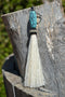 Close Up View 4 1/2" total length horsehair zipper pull with spring clip. Handmade horsehair various colors and beading pattern. White-turquoise