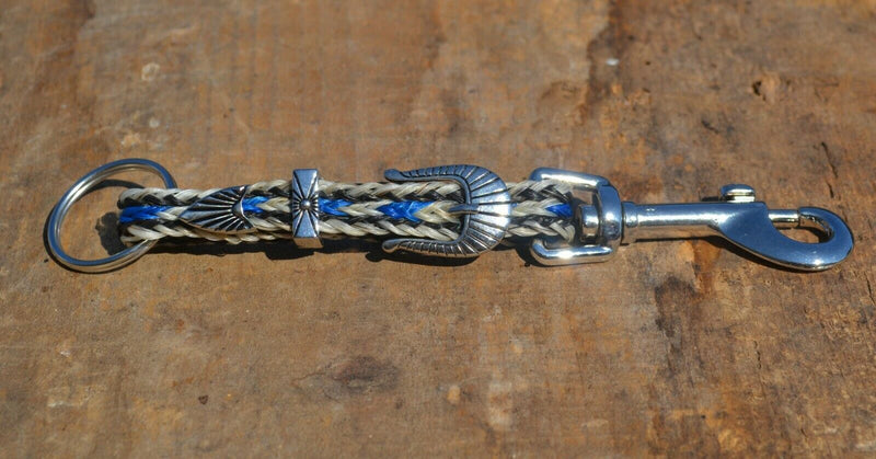 Close Up View Handmade natural horsehair braided key chain with silver tone faux buckle and snap. This key chain is about 6" long including the 1" key ring loop to connect the keys.    White/Blue/White