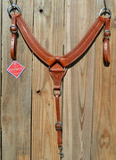 Reinsman Heavy Duty 2" Double Ply Leather Breast Collar with Hand Carved with Snake border tooling.  The chest pieces are swept upwards like a martingale style breast collar for less restrictive shoulder movement, however, it has standard tugs.  Medium honey color leather.  