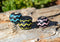 Various Colors Hand braided rawhide scarf slide.  Custom made in two-tone combinations of black and bright colored leather braided in a "zig zag" pattern.