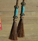 Super Close Up Detail View natural horse hair Stampede String with beads and horse hair tassels and cotter pin attachments.  Chestnut-Silver/Turquoise/Silver