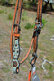 Close Up View Bit Ends Circle Y of Yoakum -  Custom 5/8" Scalloped Browband Gag Headstall  with floral tooling with antiqued wash on crown.   Browband and cheek pieces have turquoise faux gator overlay accented with antiqued parachute spots.   Antiqued copper conchos on browband and bit ends. 