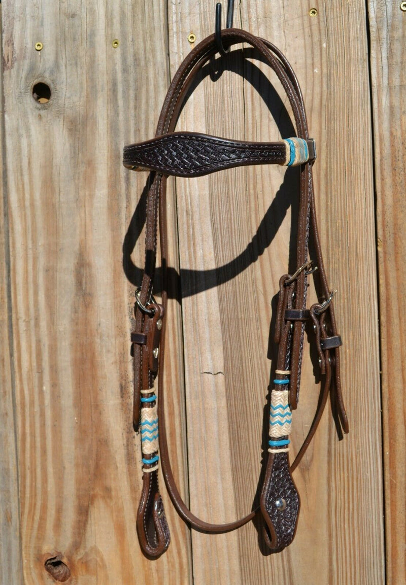 Jose Ortiz 5/8" Shape Browband Headstall.  Constructed of two-ply and stitched dark chocolate oil  finished leather.  Hand carved with Jose's signature basket weave tooling and natural hand braided rawhide with turquoise details on cheek pieces and browband