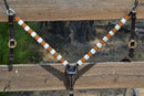 Circle Y of Yoakum - 1" Dark Oil Leather Breast Collar with Infinity Wrap Beading in a bright white, brown, gold and red southwest diamond pattern.  Stainless steel hardware.   12" adjustable tugs.