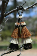 Close Up View 4" triple mule tail cut Double Tassels. Handmade horsehair dyed in bright colors as well as natural.     Chestnut/White/Black