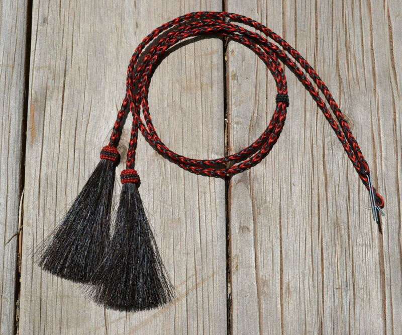 Close Up View natural horse hair stampede string with cotter pin attachments.      Black/Red/Black