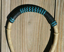 Close Up View Noseband. Jose Oritz 1/2" hand braided natural beveled rawhide bosal with natural rawhide with black leather nose with turquoise details and a traditional round shaped knot with a space between the cheek pieces.