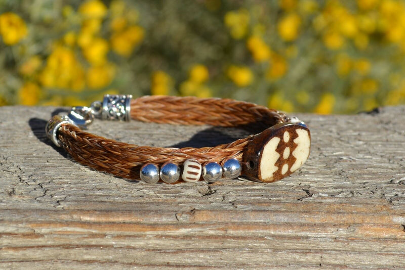 Close Up View Awesome 3/8" wide, 3 Strand Braided Horsehair Bracelet with a lobster claw clasp and various colored and patterned bone beads. Chestnut/Silver