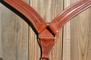 Close Up View Reinsman Heavy Duty 2" Double Ply Leather Breast Collar with Hand Carved with Snake border tooling.  Warm mahogany color leather.  Stainless steel hardware and tugs and cinch drop.   1" x 12" adjustable tugs. 