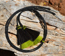 Close Up View natural horse hair Stampede String with two bell mule tail cut tassels and cotter pin attachments.    Black/Black/Lime