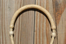 Close Up View Noseband Jose Oritz 1/4" hand braided light natural rawhide bosal with round shaped knot.  This bosal has 12 plait cheeks over a flexible all rawhide core.