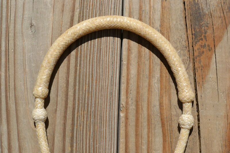 Close Up View Noseband Jose Oritz 1/4" hand braided light natural rawhide bosal with round shaped knot.  This bosal has 12 plait cheeks over a flexible all rawhide core.