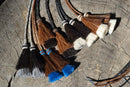 Close Up View Various Colors natural horse hair Stampede String with two bell mule tail cut tassels and cotter pin attachments. 