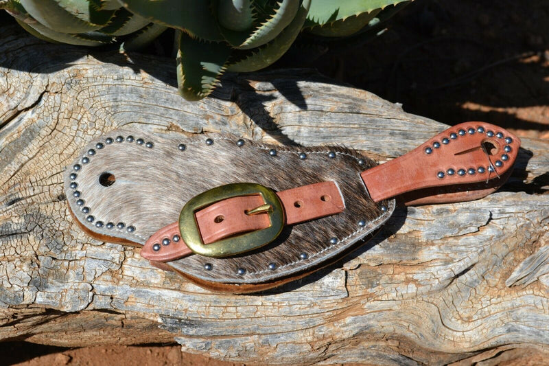 Cowboy Style Hair-On Cowhide Shaped Spur Straps.  Hair-on cowhide with grey & brown brindle coloring with stainless steel spots.  Soft distressed leather lining and Hermann Oak harness leather straps.  Brass buckles.