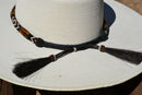 Close Up Back View Horsehair Tassels Beautiful 1/2" Hand Made Beaded Hatband with Long Bone Beads.  Made from 7 strands of black, brown and white beads and 1" wide amber color bone beads. 