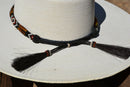 Close Up Back View Horsehair Tassels Beautiful 1/2" Hand Made Beaded Hatband with Long Bone Beads.  Made from 7 strands of black, brown and white beads and 1" wide amber color bone beads. 