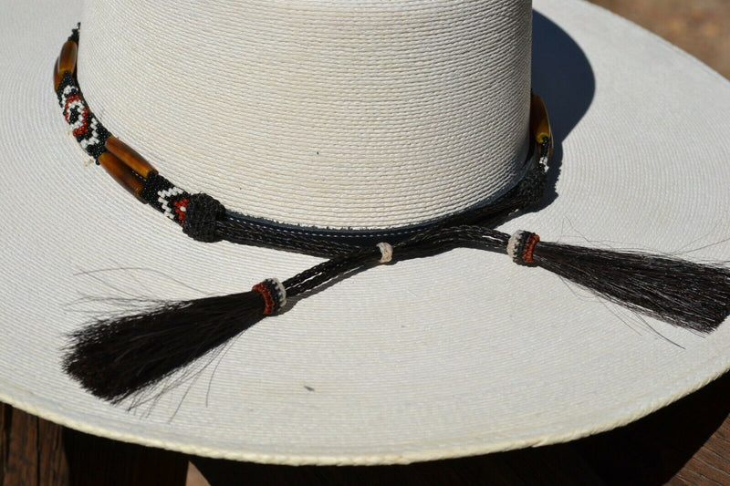 Close Up Back View Horsehair Tassels Beautiful 1/2" Hand Made Beaded Hatband with Long Bone Beads.  Made from 7 strands of black, brown and white beads and 1" wide amber color bone beads. 