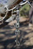 Close Up View Handmade natural horsehair braided key chain with silver tone faux buckle and snap. This key chain is about 6" long including the 1" key ring loop to connect the keys.   Grey/Black/White