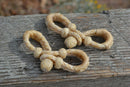 Hand Braided Natural Rawhide Bit/Rein Connector.  Made from 4 plait natural rawhide with sliding knot and loop attachment.  Approx. 4" long.  Sold n pairs.  Single replacement connectors also available.