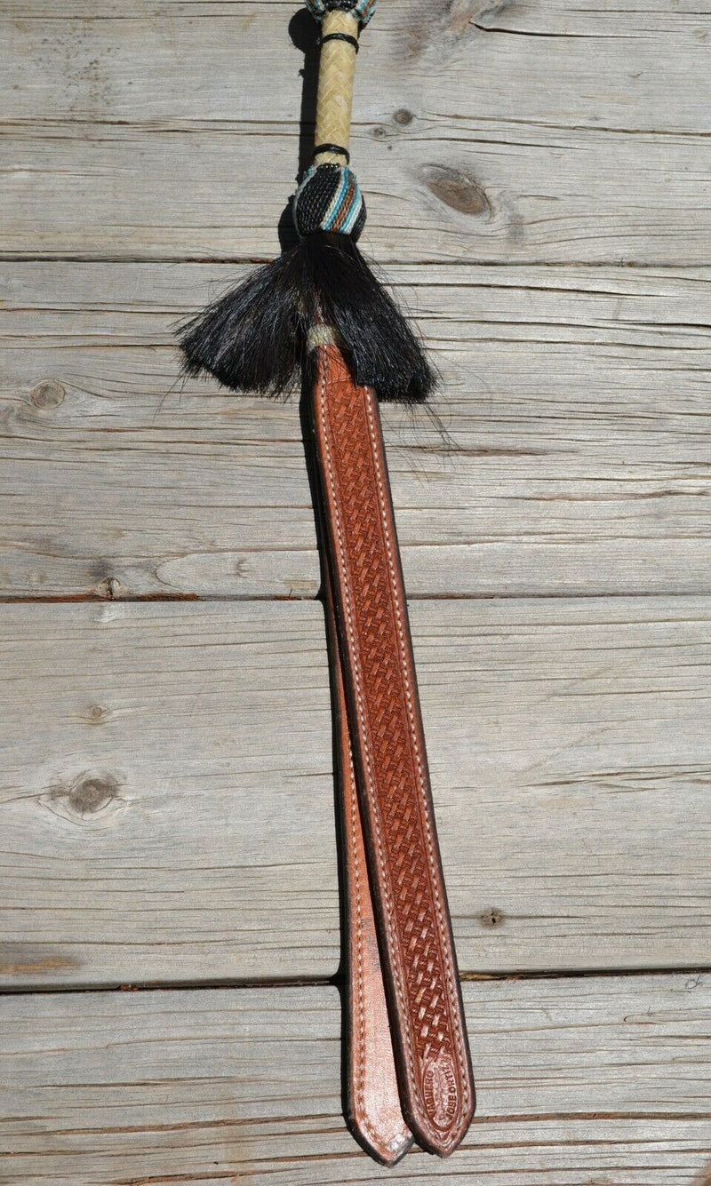 Close Up View Beautiful Jose Ortiz  Braided Rawhide Quirt Whip with Hitched Horsehair Knots, black horsehair tassels and Hand Tooled Leather Popper.   Natural colored rawhide with turquoise blue, tan and black details. 