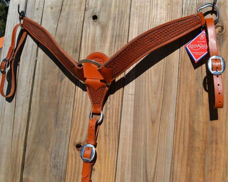 Reinsman Heavy Duty 2 3/4" Double Ply Leather Breast Collar with Hand Carved with mini basket weave tooling.  Reinsman's "Old West"  color leather.  Stainless steel hardware and tugs and cinch drop.   1" x 12" adjustable tugs. 