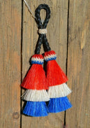 Close Up View 4" triple mule tail cut Double Tassels. Handmade horsehair dyed in bright colors as well as natural.    Red/White/Blue