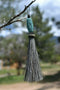 Close Up View 4 1/2" total length horsehair zipper pull with spring clip. Handmade horsehair various colors and beading pattern. Grey-Turquoise