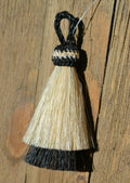 Close Up View 3" two Bell mule tail cut natural and brightly colored tassels. Handmade from horsehair dyed in bright colors as well as natural.     White/Black