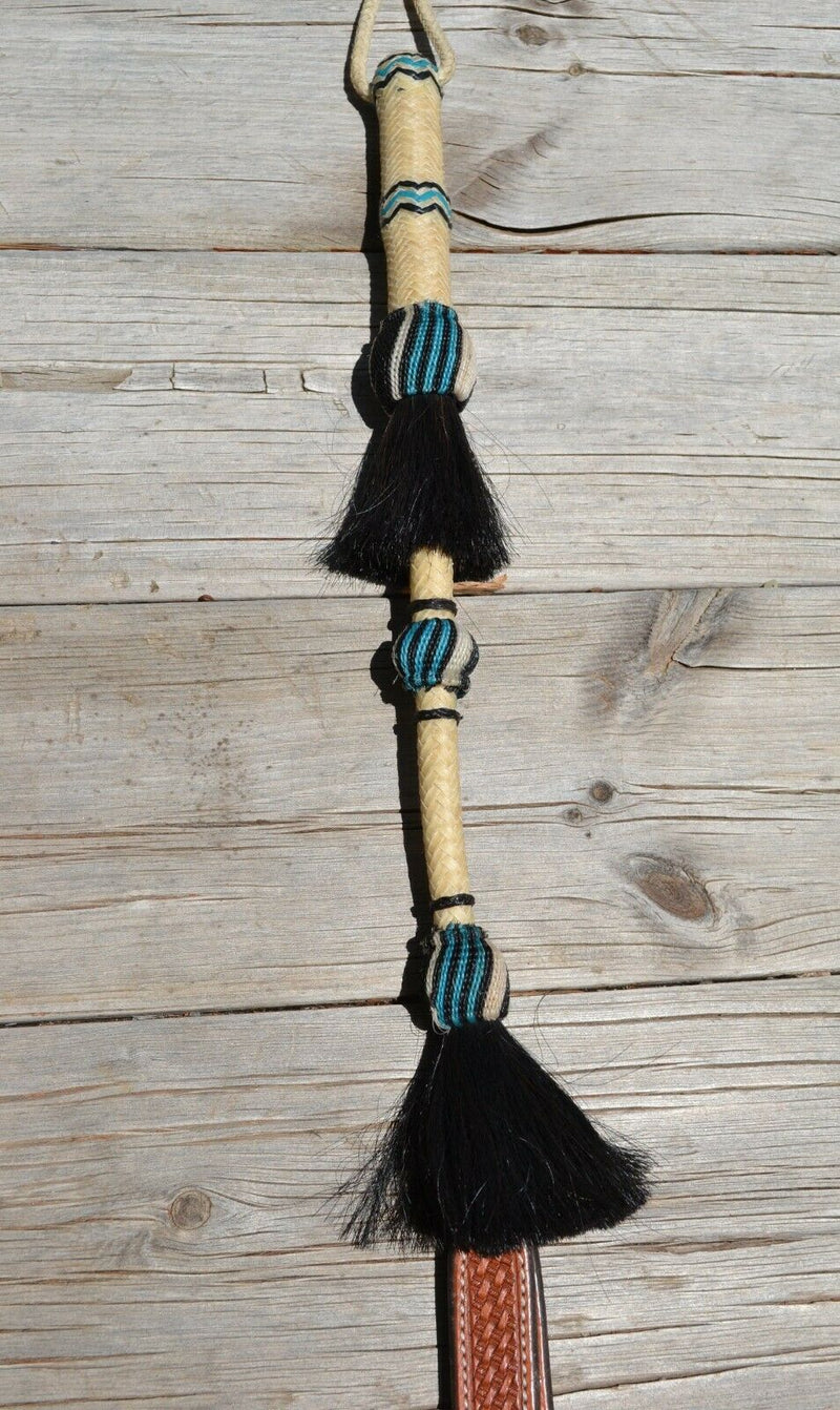Close Up View Beautiful Jose Ortiz Braided Rawhide Quirt Whip with Hitched Horsehair Knots and Hand Tooled Leather Popper. Natural colored rawhide with turquoise blue and black details. 