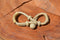 Close Up Single View Hand Braided Natural Rawhide Bit/Rein Connector.  Made from 4 plait natural rawhide with sliding knot and loop attachment.  Approx. 4" long.  Sold n pairs.  Single replacement connectors also available.