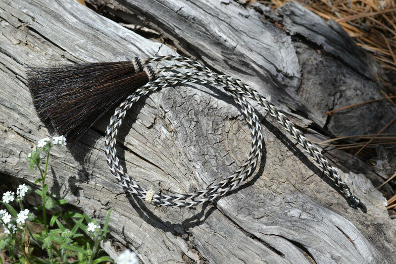 Close Up View Western Style 1/4" wide and 24" long, braided horse hair eye glass holder (gator/leash) with tassels.    Black & White