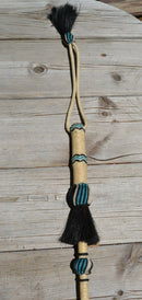 Close Up View Beautiful Jose Ortiz Braided Rawhide Quirt Whip with Hitched Horsehair Knots and Hand Tooled Leather Popper. Natural colored rawhide with turquoise blue and black details. 