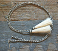 Close Up View natural horse hair stampede string with cotter pin attachments. Black/White/White