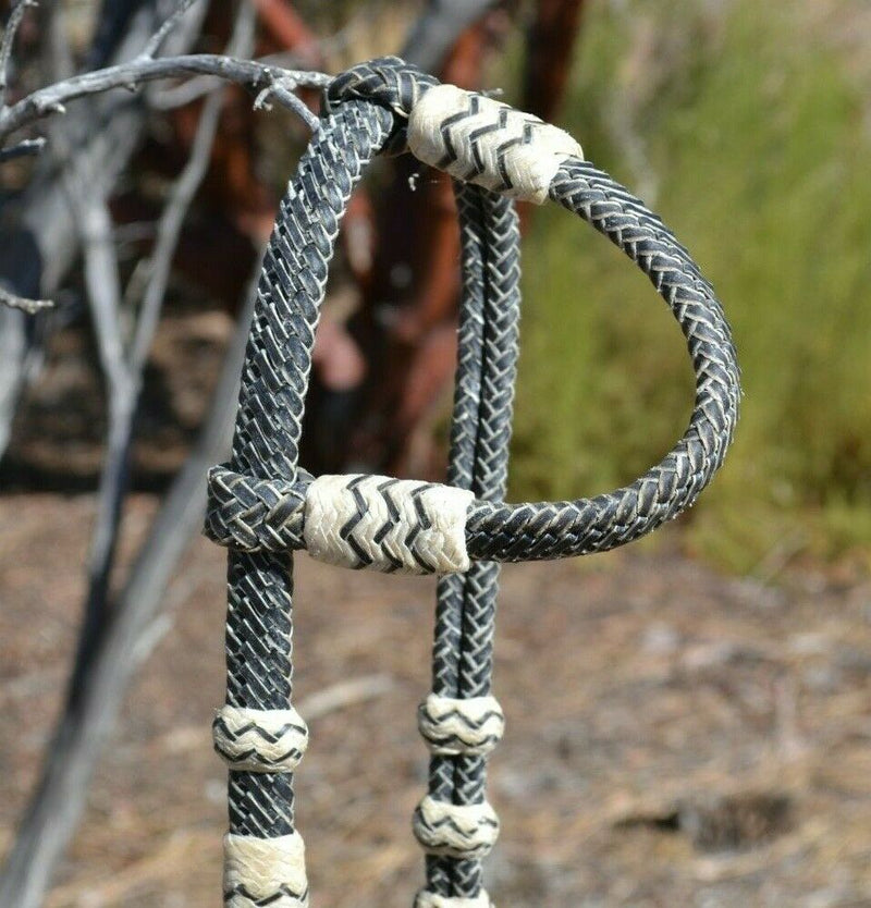 Close Up View Jose Ortiz 5/8" Single One Ear Santa Maria Style Headstall.  Constructed of  12 plait black beveled rawhide with light natural rawhide details.  