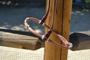 Close Up View Jose Ortiz has made these beautiful rolled harness leather adjustable western training cavesons with latigo hangers.   Made from beautifully conditioned Hermann Oak harness leather with 3 natural rawhide knots with burgundy latigo details over the nose and natural rawhide hanger knots.  