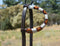 Close Up View single ear headstall. Circle Y of Yoakum - Unique Infinity Wrap One Ear Headstall with brown, red, yellow and white. Dark oil leather and replaceable buckles.  Ties at bit ends.