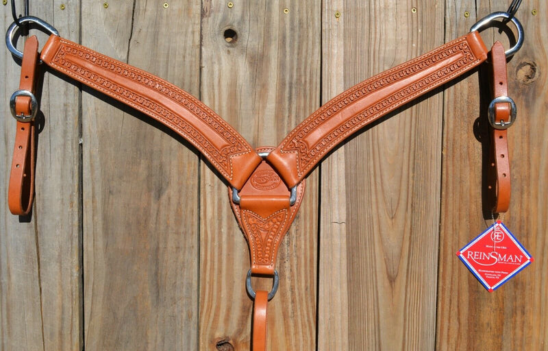 Reinsman Heavy Duty 2" Double Ply Leather Breast Collar with Hand Carved with Snake border tooling.  Light honey color leather.  Stainless steel hardware and tugs and cinch drop.   1" x 12" adjustable tugs. 