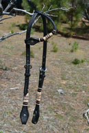 Jose Ortiz 5/8" One Single Ear Headstall.  Constructed of two-ply and stitched black finished leather.  Hand carved with Jose's signature basket weave tooling and natural hand braided rawhide with burgundy latigo details on cheek pieces and ear pieces.   