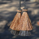 Super Close Up View natural horse hair Stampede String with two bell mule tail cut tassels and cotter pin attachments. 
