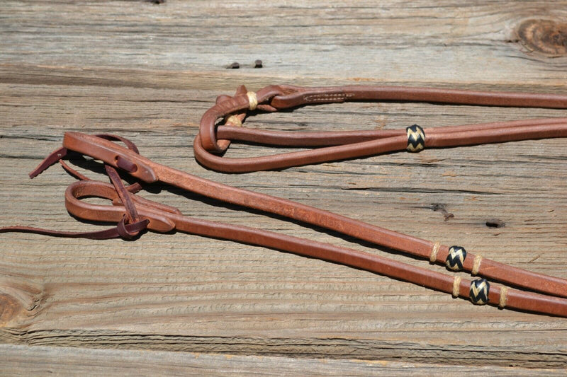 Close Up View Jose Ortiz 1/2" Hermann Oak Harness Leather Romel Reins with Hand Braided Natural Rawhide Buttons with black details.  Leather is super preconditioned  with hand rubbed edges and ready to ride.   