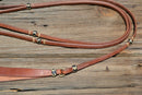 Jose Ortiz 1/2" Hermann Oak Harness Leather Romel Reins with Hand Braided Natural Rawhide Buttons with black details.  Leather is super preconditioned  with hand rubbed edges and ready to ride.   