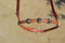 Close Up Front View Jose Ortiz has made these beautiful rolled harness leather adjustable western training cavesons with latigo hangers.   Made from beautifully conditioned Hermann Oak harness leather with 3 natural and black and natural rawhide knots over the nose and natural rawhide hanger knots. 
