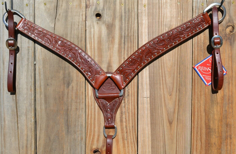 Reinsman Heavy Duty 2" Heavy Oil Double Ply Harness Leather Breast Collar with Hand Carved Arizona Flower tooling with spots.  Stainless steel hardware and tugs and cinch drop.   1" x 12" adjustable tugs. 