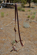 Jose Ortiz has made these beautiful  adjustable western training cavesons with latigo hangers.   Made from natural rawhide over the nose with an adjustable latigo chin strap that will fit a larger variety of horses.