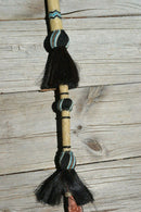 Close Up View Beautiful Jose Ortiz Braided Rawhide Quirt Whip with Hitched Horsehair Knots, black horsehair tassels and Hand Tooled Leather Popper. Natural colored rawhide with turquoise blue, tan and black details. 