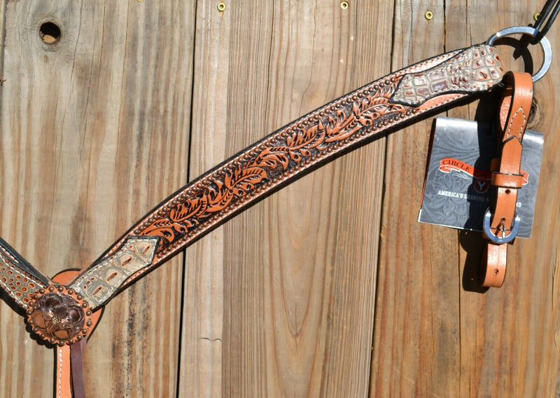 Close Up View Circle Y of Yoakum - Shaped 3-Piece Breast Collar with Tan Faux Gator, Floral Tooling and Antiqued Copper spots.    Stainless steel hardware.   Antiqued finish and latigo tie down keeper.  Elastic choke strap gives has the horse moves.  12" adjustable tugs.  Horse size. 