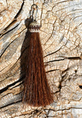 Close Up View 3" total length natural horsehair zipper pull with spring clip. Handmade from 100% natural mane horsehair. Chestnut