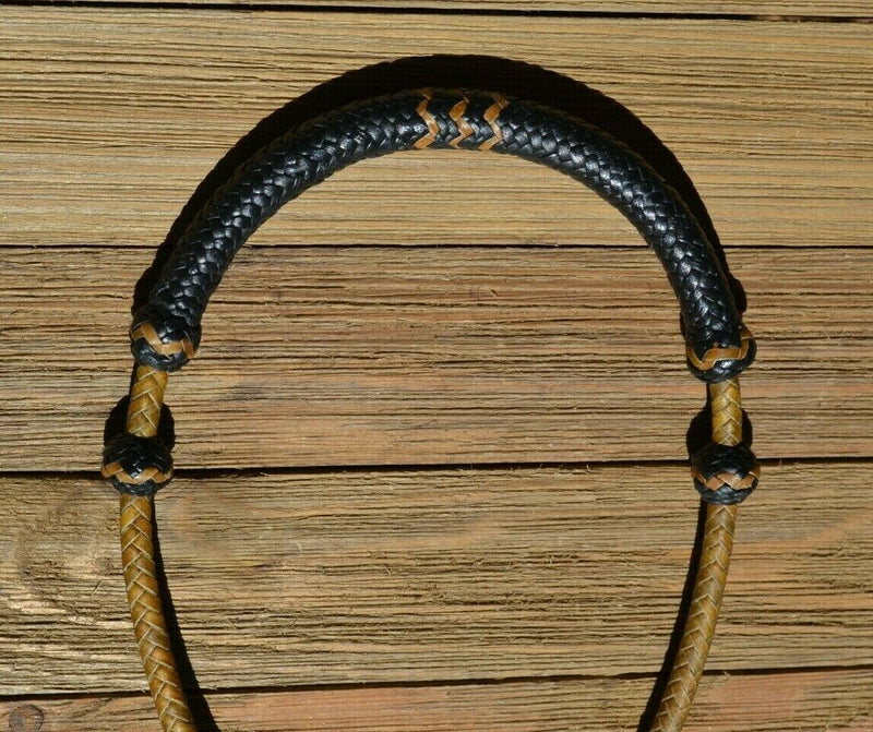 1/4" hand braided dark natural rawhide pencil bosal with a rawhide core and black calf leather nose and knot with tan details.  Noseband measures 1/2" wide at the thickest point. 