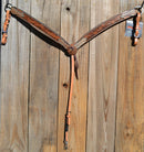 Circle Y of Yoakum - Shaped 3-Piece Breast Collar with Tan Faux Gator, Floral Tooling and Antiqued Copper spots.    Stainless steel hardware.   Antiqued finish and latigo tie down keeper.  Elastic choke strap gives has the horse moves.  12" adjustable tugs.  Horse size. 