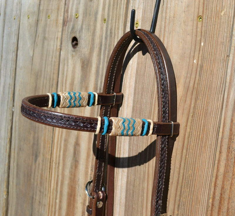 Jose Ortiz 5/8" Straight Browband Headstall.  Constructed of two-ply and stitched dark chocolate oil  finished leather.  Hand carved with Jose's signature basket weave tooling and natural hand braided rawhide with turquoise details on cheek pieces and browband.